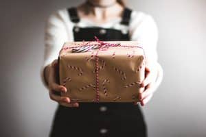 a woman giving gift in holiday season